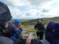 Clive tries to take a photo on the windy summit