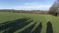 Walker shadows taking view of the distant high fells 